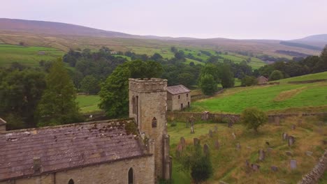 Drone-aerial-reverse-of-church-in-Yorkshire-Dales