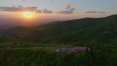 Vivid-sunset-drone-view-from-over-Santiago-Mountains,-Santiago-de-los-Caballeros
