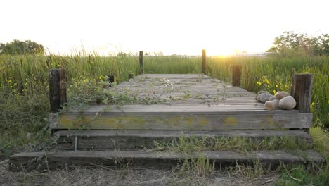 Rustic-view-of-sun-setting-by-a-dock