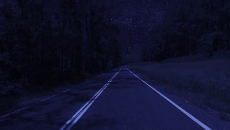 Rear-facing-night-driving-point-of-view-POV-for-interior-car-scene-green-screen-replacement---night-footage-under-a-clear-starry-sky,-on-quiet-deserted-outback-roads,-with-brooding-trees-either-side