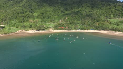 Drone-Aéreo-De-La-Hermosa-Costa-Con-Agua-Azul-Cristalina-Y-Pequeños-Barcos-De-Pesca-Y-Pescadores-En-El-Sudeste-Asiático