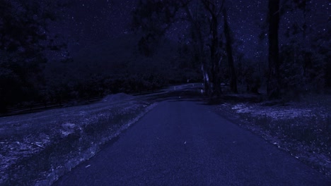 Rear-facing-night-driving-point-of-view-POV-for-interior-car-scene-green-screen-replacement---night-under-a-clear-starry-sky,-on-quiet-deserted-country-roads,-with-ominous-mountain-in-background