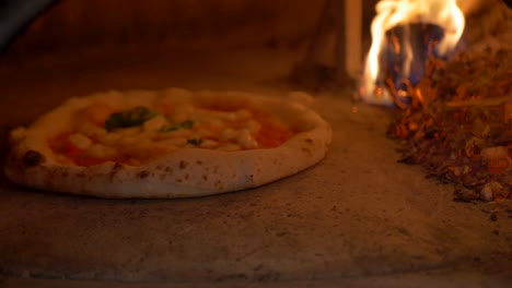 Making-pizza-in-wooden-oven-4K