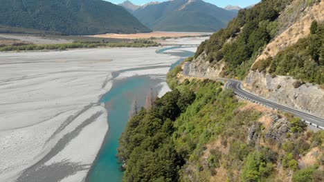 Aerial-clip-of-a-road-near-a-plain-landscape-in-New-Zealand,-with-the-camera-moving-forward