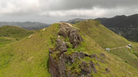 Aerial-orbit-view-around-a-small-group-of-friends-on-a-rock-peak-in-the-Osma-Peak-area,-Philippines