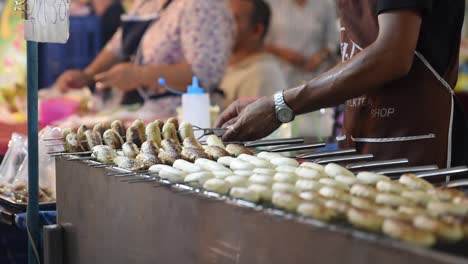 Thailand-street-food-vendor-grilling-a-baked-whole-bananas