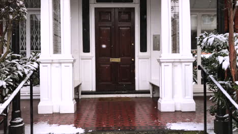 Home-Sweet-Home---Snowy-scene-coming-in-out-of-the-cold-entering-a-wooden-front-door-into-a-Mansion-House