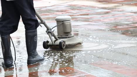 Closeup-shot-of-a-man-operating-an-industrial-floor-cleaning-machine