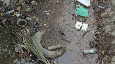 Dirty-water-inside-a-small-canal-with-a-lot-of-garbage
