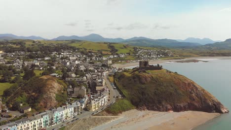 Criccieth---Pearl-of-Wales-on-the-Shores-of-Snowdonia---aerial-drone-image-rising-above-11th-century-Criccieth-Castle-and-Dinas,-with-views-towards-Snowdonia---4K-23