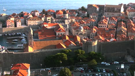 Zooming-in-over-medieval-walled-city-of-Dubrovnik,-Croatia-on-the-Adriatic-Sea,-where-Game-of-Thrones-was-filmed