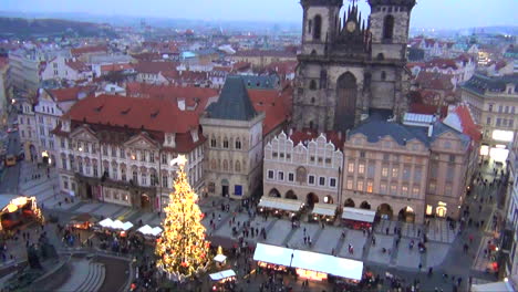 Prague,-Czech-Republic-Christmas-Markets-aerial-view-from-Belltower-of-musical-Christmas-Tree-in-front-of-the-iconic-church-Old-Lady-before-Tyn