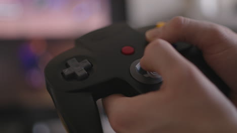 Close-up-of-hands-playing-a-classic-1990s-video-game-controller