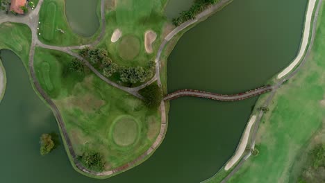 Aerial-top-down-forward-footage-of-green-golf-course-in-Thailand