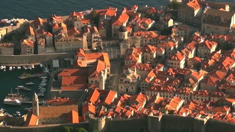 Zooming-in-over-medieval-walled-city-of-Dubrovnik,-Croatia-on-the-Mediterranean-Sea,-where-Game-of-Thrones-was-filmed