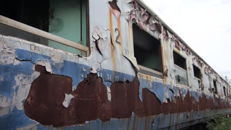 Old-rusty-abandoned-train-with-windows-sitting-in-the-graveyard