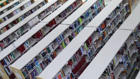 Top-down-panning-shot-of-rows-of-book-shelves-in-a-library