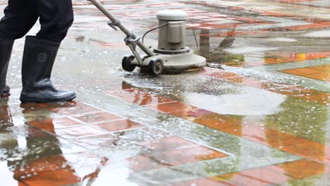 Closeup-shot-of-a-man-using-industrial-floor-cleaning-machine