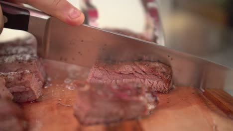 Chef-cutting-hot-medium-rare-flank-beef,-slow-motion