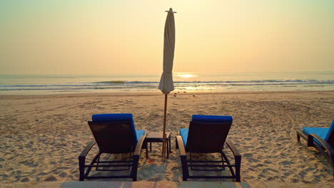 umbrella-chair-beach-with-palm-tree-and-sea-beach-at-sunrise-times