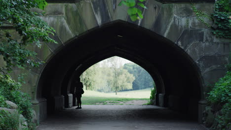 A-person-walks-through-a-tunnel-in-Prospect-Park-in-Brooklyn,-NY