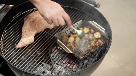 Chef-stirring-grilled-and-seasoned-potatoes-over-a-hot-grill