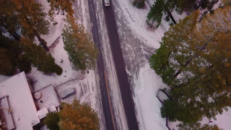 Drone-shot-of-snowy-road-near-lake-tahoe-in-the-morning