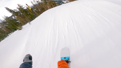 POV-shot-of-snowboarder-riding-down-a-mountain