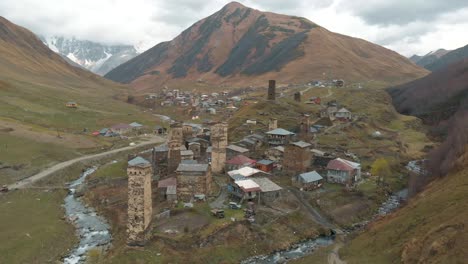 Drone-flying-away-from-an-old-village-in-Georgia-hidden-in-the-Caucasus-Mountains