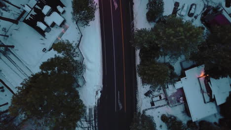 Drone-shot-of-a-snowy-road-in-the-evening-near-Lake-Tahoe