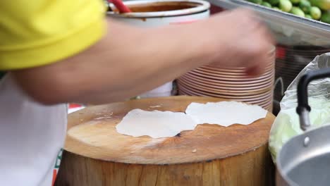 Chef-Separating-Rice-Paper-And-Starts-Preparing-Asian-Wraps,-CLOSE-UP
