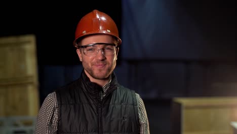 the-worker-puts-on-his-helmet-and-starts-looking-into-the-camera