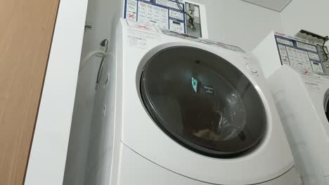 A-commercial-coin-operated-Japanese-combo-washing-machine-dryer-combo-doing-exactly-what-it's-made-to-do
