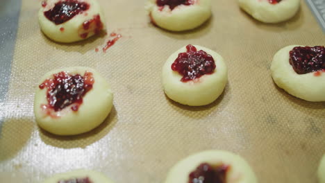 uncooked-jam-filled-sugar-cookies-on-a-baking-tray