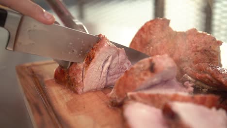 Closeup-of-a-chef-cutting-a-pork-beef,-slow-motion