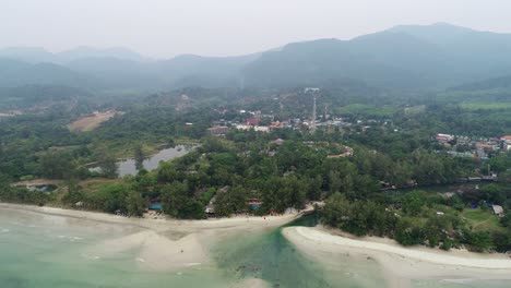 Beautiful-hotel-resorts-by-the-beach-of-Thailand-with-mountains-in-the-background---aerial