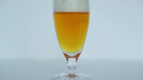Makro-Nahaufnahme-Eines-Vollen-Glases-Bier,-In-Dem-Sich-Blasen-Langsam-Zur-Spitze-Eines-Glases-Mit-Schöner-Bierfarbe-Bewegen,-Mit-Schaum-Oben-In-Normaler-Geschwindigkeitsbewegungserfassung