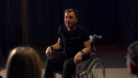 a-man-in-a-wheelchair-tells-the-people-standing-in-front-of-him