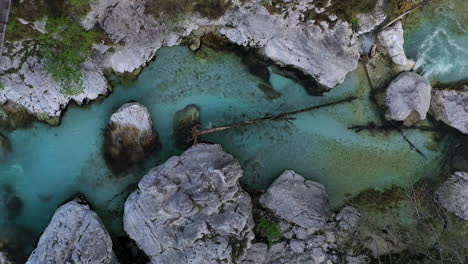 Top-down-view-of-the-Soča-river-in-Slovenia-as-drone-rises-to-reveal-landscape