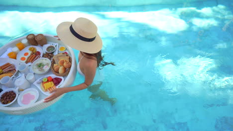 Top-view-of-Fit-woman-holding-floating-exotic-breakfast