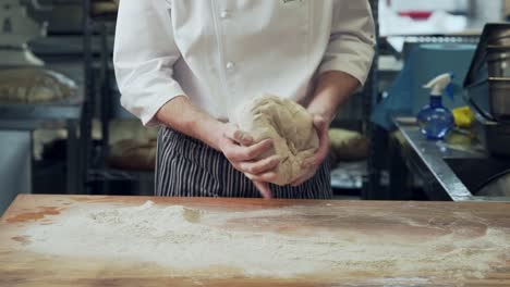 closeup,-baker-hands-kneading-dough-on-rye-bread