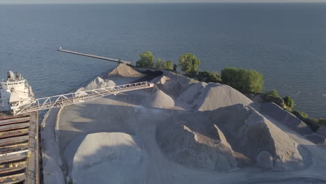 A-Large-Gravel-Slinger-At-Work-In-A-Sand-Quarrying-Plant-By-The-Sea-In-Kingsville,-Ontario,-Canada---aerial