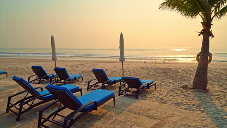 umbrella-chair-beach-with-palm-tree-and-sea-beach-at-sunrise-times