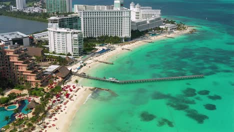 Aerial-drone-view-over-hotel-resorts-and-the-Carribean-sea,-in-Cancun-Mexico