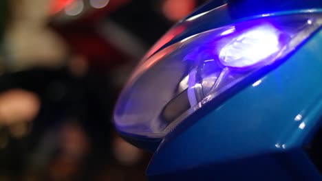Motorcycle-turn-signal-lights-in-blue-with-background-blur