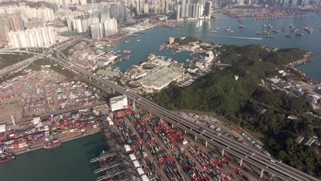 Wide-view-of-Hong-Kong-Container-terminal-and-port-at-Victoria-bay-with-storage-terminal-and-docked-Ships,-Aerial-footage