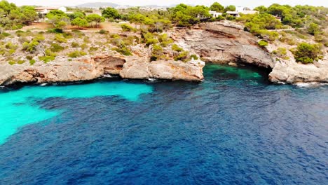 Aerial-view-lagoon-of-rocky-coast-Mallorca-island,-Spain,-panning