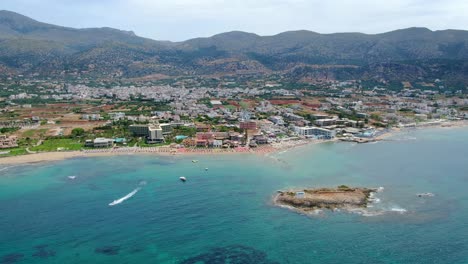 Aerial-panorama-on-blue-mediterranean-sea-and-Greece-resort-town,-Crete