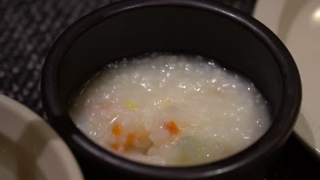 Korean-Vegetable-Rice-Porridge-mixing-with-spoon-close-up