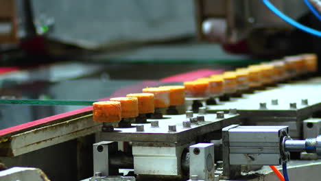 Close-up-of-the-process-of-polishing-and-grinding-glass-through-polishing-machine,-at-glass-manufacturing-industry